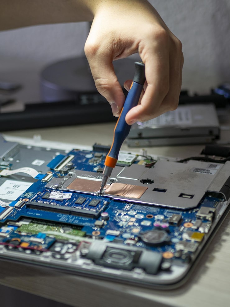 vertical-shot-person-repairing-tablet-with-screwdriver_665346-152088